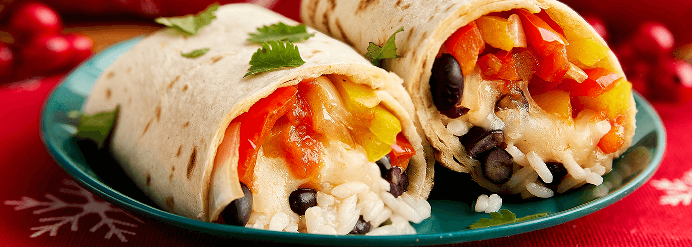 yummy and cheesy christmas vegetarian fajita burrito wraps served on blue plate