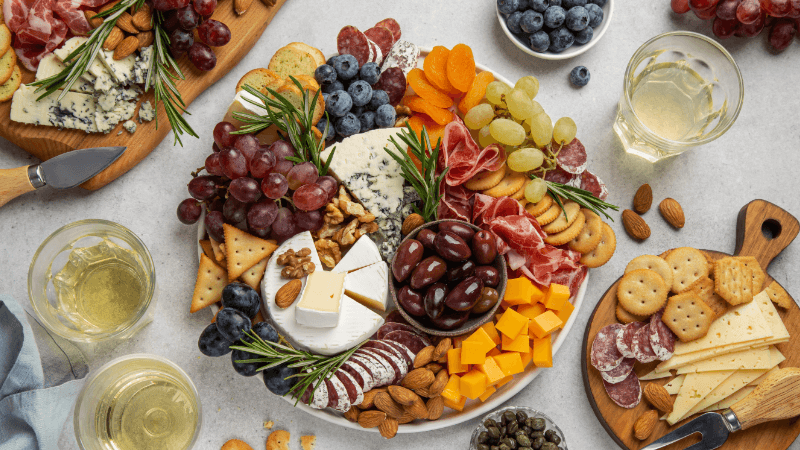 charcuterie board with assorted food items & garnished served on table