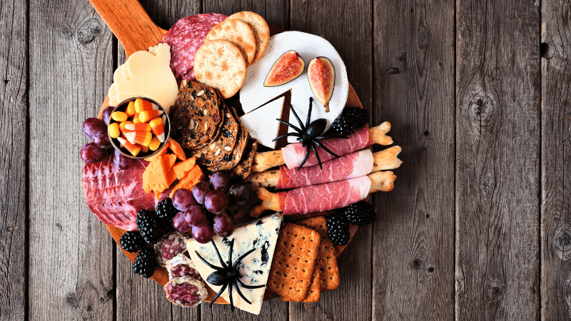 Halloween theme charcuterie board placed on wooden table