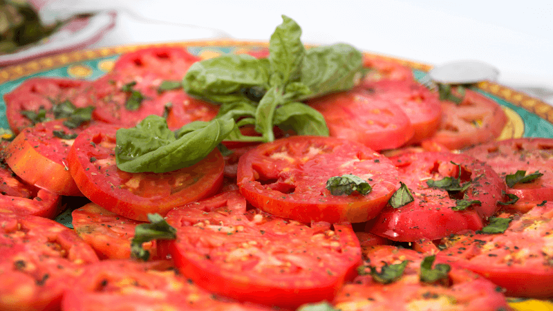 a plate of seasoned sliced tomatoes