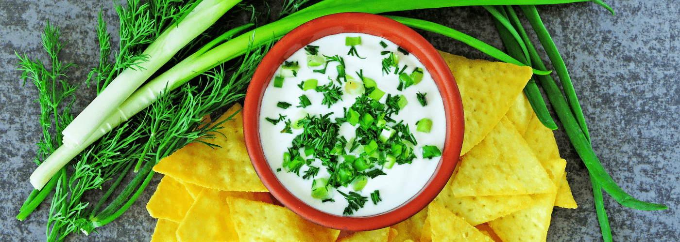 soured cream garnished with cilantro served with chips
