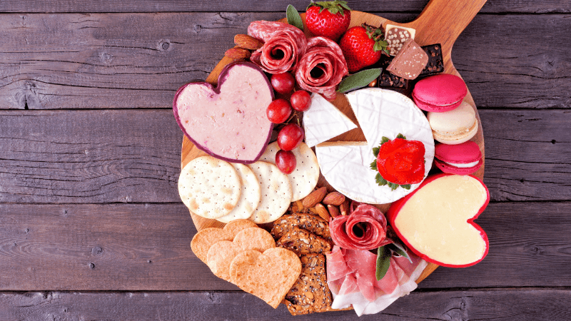 valentine's theme charcuterie board placed on wooden table