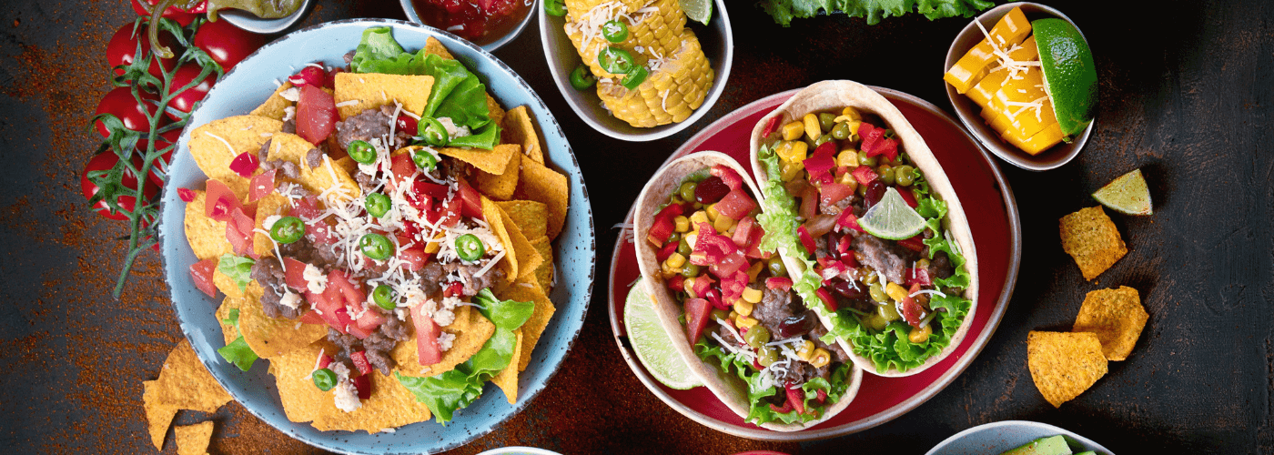 delicious Mexican meal such as tacos, burritos, nachos etc. served on table