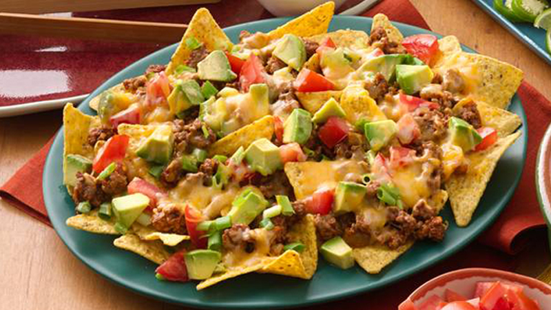 easy beef nachos served on green plate