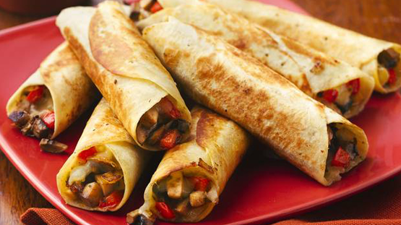 Pan-Fried Mushroom and Cheese Flautas served on a red plate