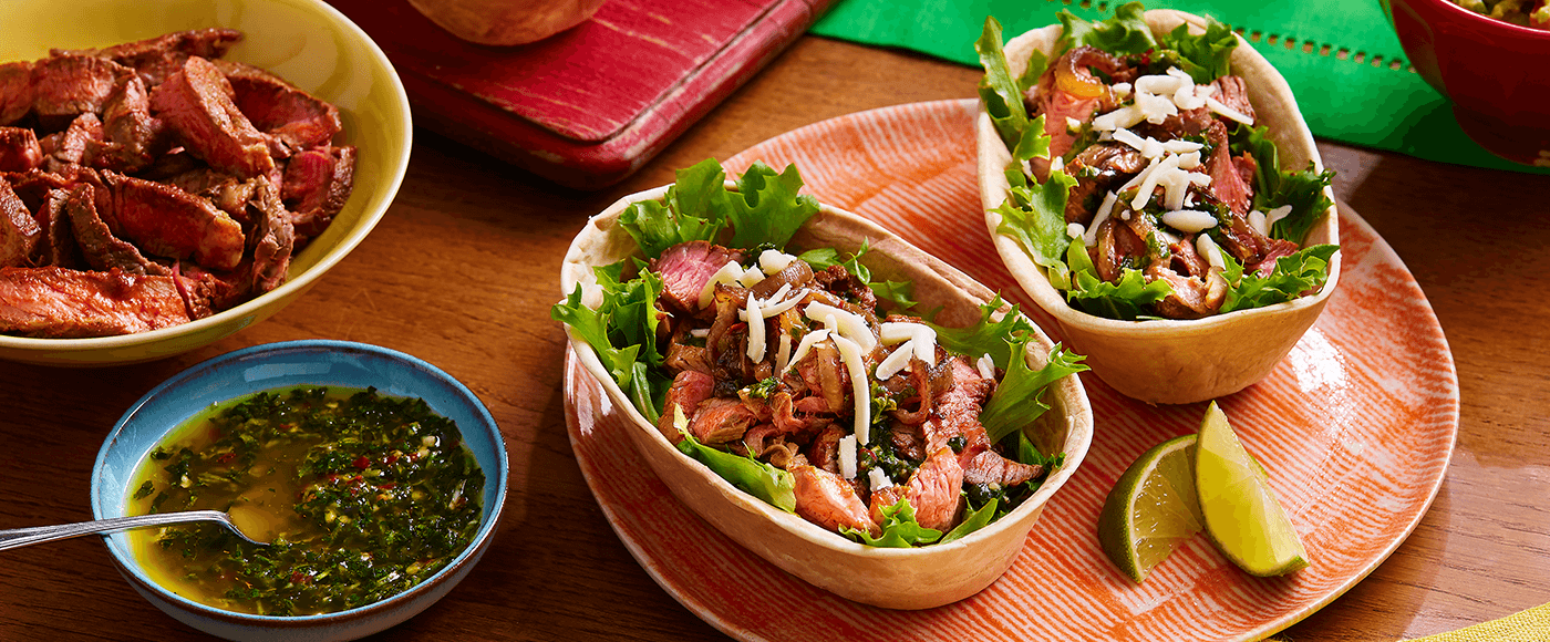 steak tacos with chimichurri served on a brown plate