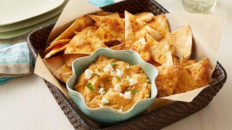 taco hummus served with tortillas chips